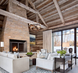East fork living room wood beams stone fire place glass sliding doors