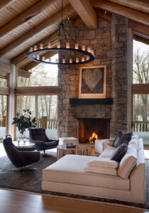 Big Wood River Front living room stone fireplace spacious floor to ceiling windows
