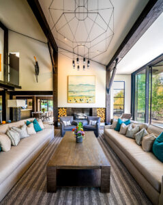 North of Ketchum Riverfront living room patio bright light glass sliding doors wood beams light fixture