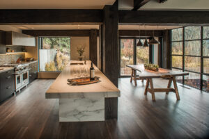 North of Ketchum Riverfront kitchen dining room open space granite countertops large windows wood beams