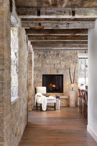 East fork nook fire place wood beams stone walls warm tones
