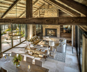 East fork living room fire place wood beams stone walls warm tones